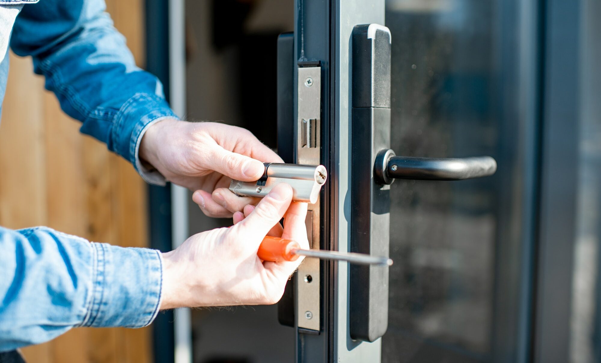 Man changing core of a door lock