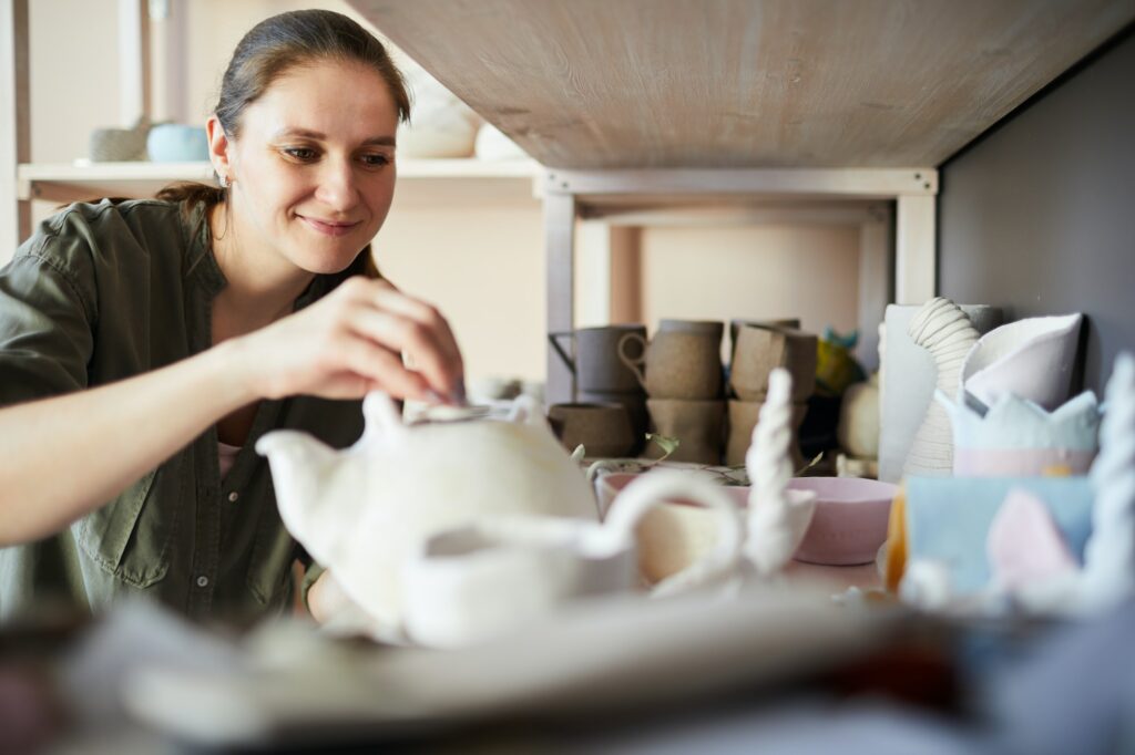 Smiling Female Potter in Storage Room